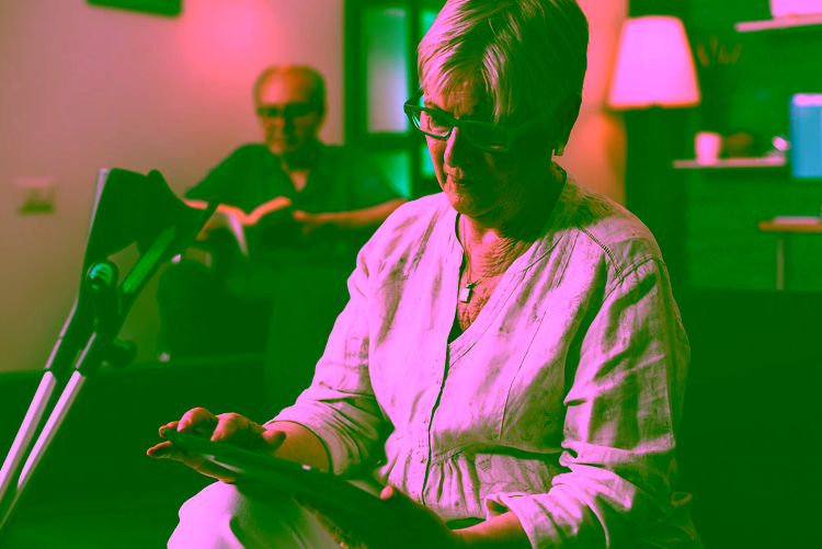 senior-person-with-crutches-looking-modern-tablet